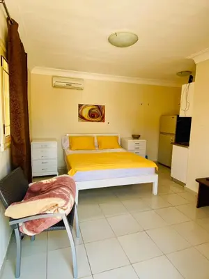 a bedroom with a bed and a chair in it at studio for daily rent in Hurghada