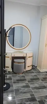a bathroom with a vanity with a mirror and a toilet at New Apartment for short and long term in Hurghada