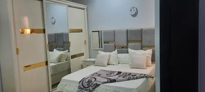 a bedroom with a large bed and a mirror at New Apartment for short and long term in Hurghada