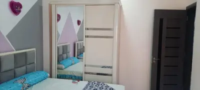a bedroom with a mirror and a bed in a room at New Apartment for short and long term in Hurghada