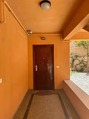 a hallway with a door in an orange wall at The View Club House in Hurghada
