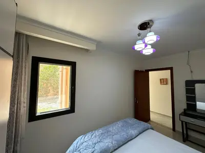 a bedroom with a bed and a window at The View Club House in Hurghada