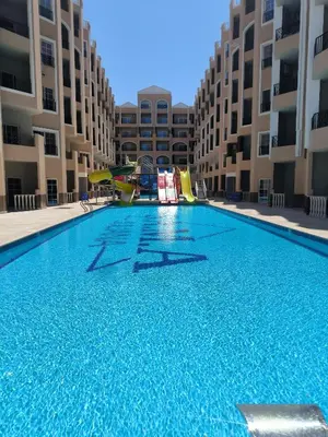 a large swimming pool in the middle of a building at Terracotta studio with amazing beach and sea view in Hurghada