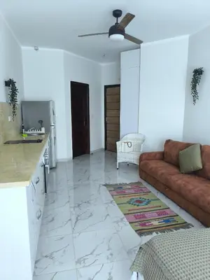 a living room with a couch and a kitchen at Terracotta studio with amazing beach and sea view in Hurghada