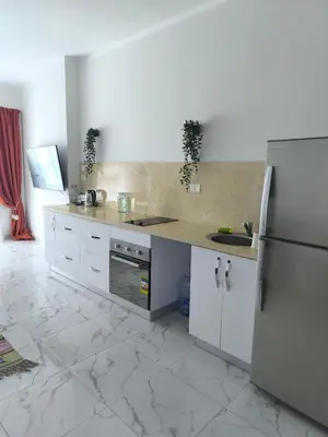 a kitchen with a counter and a refrigerator at Terracotta studio with amazing beach and sea view in Hurghada