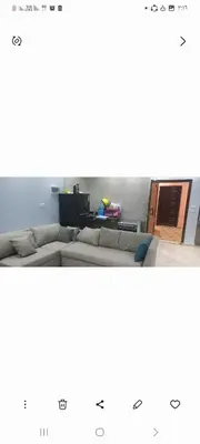 a living room with a couch and a table at Ikea flat 10 in Hurghada