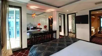 a bedroom with a bed and a living room at Five Star Nile Cruise from Aswan to Luxor in Aswan