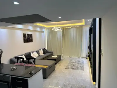 a living room with a couch and a tv at S 22 Marina City in Port Ghalib