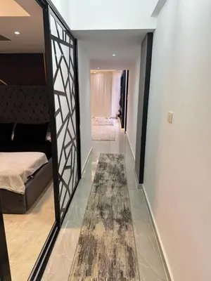 a hallway with a mirror and a bed and a rug at S 22 Marina City in Port Ghalib