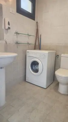 a washing machine in a bathroom with a toilet at Studio in old Sheraton in Hurghada