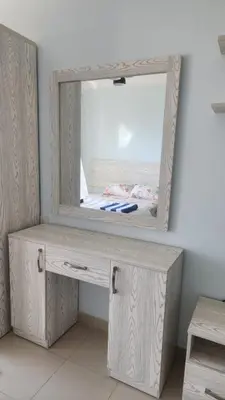 a dressing table with a mirror on a wall at Studio in old Sheraton in Hurghada