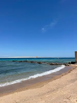 a beach with the ocean on a sunny day at Studio in old Sheraton in Hurghada