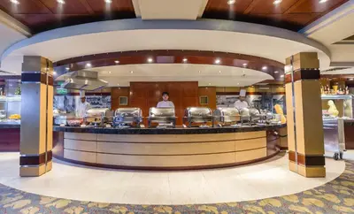 a restaurant with three people standing at a counter at live Nile in style Nile cruise in Luxor and Aswan in Luxor