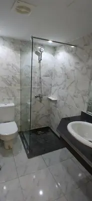 a bathroom with a shower and a toilet and a sink at Hurghada Mirage Bay Hotel & Aquapark in Hurghada