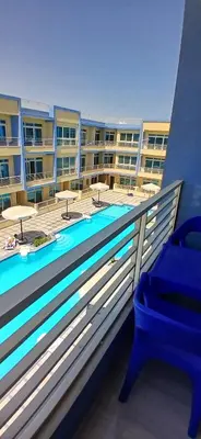 a balcony of a apartment building with a swimming pool at Hurghada Mirage Bay Hotel & Aquapark in Hurghada