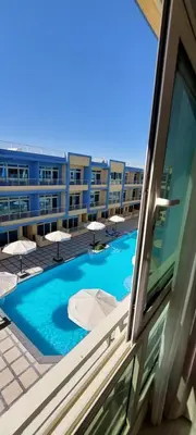a view of a swimming pool from a window of a building at Hurghada Mirage Bay Hotel & Aquapark in Hurghada