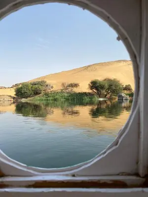 a view of a body of water through a window at 2nights Felucca from aswan to komobo temple in Aswan