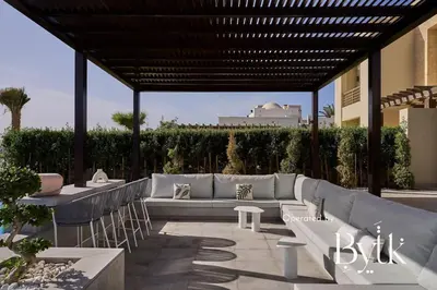 a patio with couches and tables at BYTK - Casamigos in Hurghada