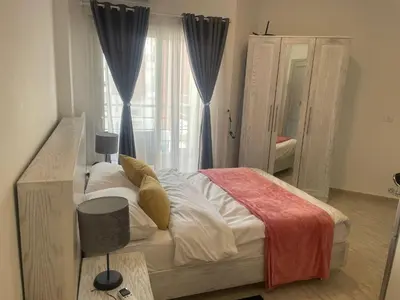 a bedroom with a large bed and a window at Fabulous studio 8 mins drive to El Gouna gates in Hurghada