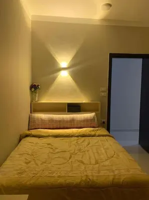 a bedroom with a bed with a light on the wall at 2 room Appartement in Hurghada