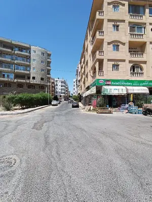 an empty street in front of a building at 2 room Appartement in Hurghada