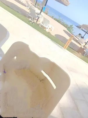 a white bath tub with a view of a beach at 2 room Appartement in Hurghada