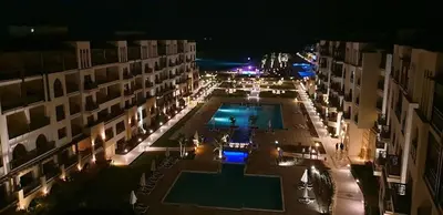 a view of a courtyard with a pool at night at Private Room Hurghada for rent beach and pools included Not Valid for Locals in Hurghada