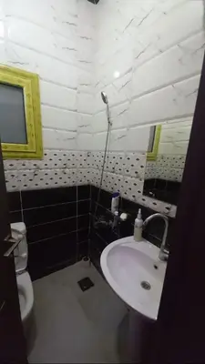 a bathroom with a sink and a toilet and a mirror at Hurghada in Hurghada