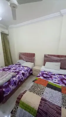 two beds sitting next to each other in a room at Hurghada in Hurghada