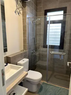 a bathroom with a toilet and a sink and a shower at El Gouna Cyan Villa with pool n lagoon by BFG Beit Fel Gouna in Hurghada
