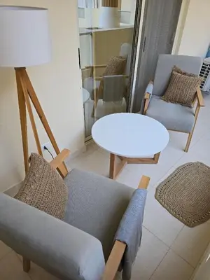 a living room with a couch and chairs and a table at Florenza Khamsin Apartments in Hurghada