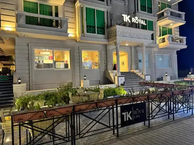 a building with a table with plants in front of it at TK Royal & Spa in Hurghada