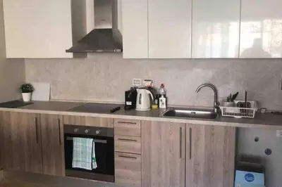 a kitchen with a sink and a stove top oven at Cozy Ground floor-Pool view - Mangroovy El Gouna in Hurghada