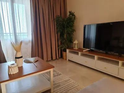 a living room with a large flat screen tv at One bedroom in the view in Hurghada