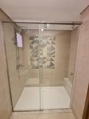 a shower with a glass door in a bathroom at One bedroom in the view in Hurghada