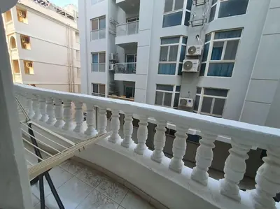a balcony with a white railing in front of a building at Hurghada city center in Hurghada