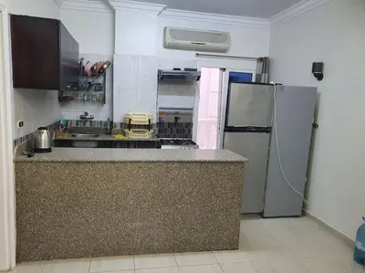 a kitchen with a counter and a refrigerator at Hurghada city center in Hurghada