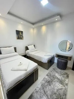 a hotel room with two beds and a mirror at Florenza Khamsin Resort in Hurghada