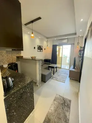 a kitchen and a living room with a counter top at Florenza Khamsin Resort in Hurghada