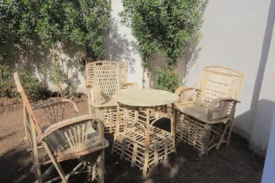 a group of chairs and a wooden table and chairsitures at Happy house in Luxor
