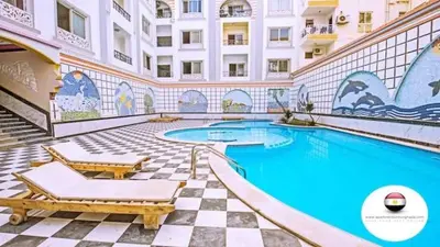a large swimming pool in a building with a building at Sheraton Plaza Retreat in Hurghada