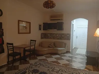a living room with a couch and a table at Sheraton Plaza Retreat in Hurghada