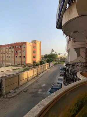 an empty street with cars parked on the side of a building at Welcome to LLL (Love Life Luxor) in Luxor