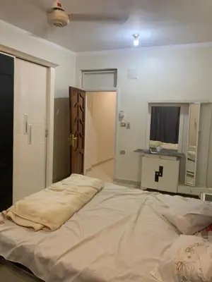 a large bed sitting in a room with a door at Welcome to LLL (Love Life Luxor) in Luxor