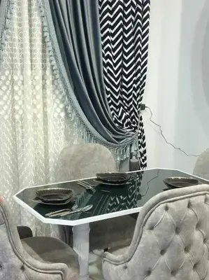 a table and chairs with plates on top of it at Luxurious Studio Apartment. in Luxor