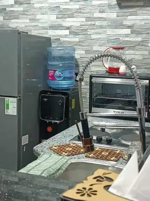 a kitchen with a sink and a counter top with food at Luxurious Studio Apartment. in Luxor