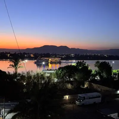 a view of a river with a van in a parking lot at Luxurious Studio Apartment. in Luxor