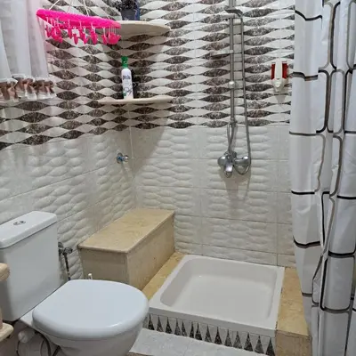 a bathroom with a toilet and a bath tub at Luxurious Studio Apartment. in Luxor