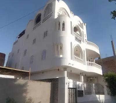 a white building with a tower on top of it at Luxor Palm Villa in Luxor
