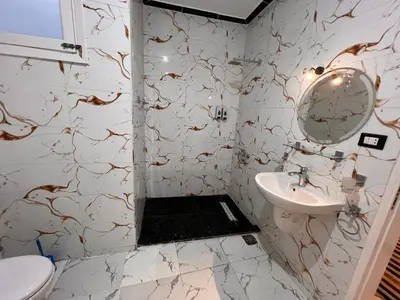 a white bathroom with a sink and a mirror at Luxor Sun Villa in Luxor